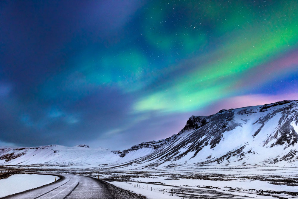 Aurora Borealis seen over a road in Budir, Iceland.